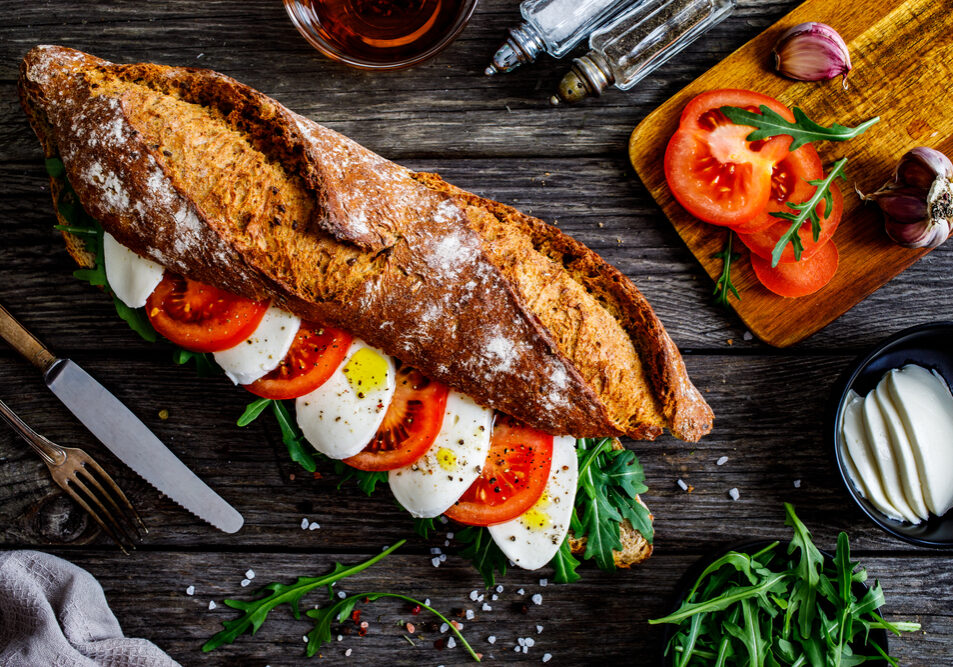 Caprese,Sandwich,With,Tomato,,Mozzarella,And,Arugula,On,Wooden,Table